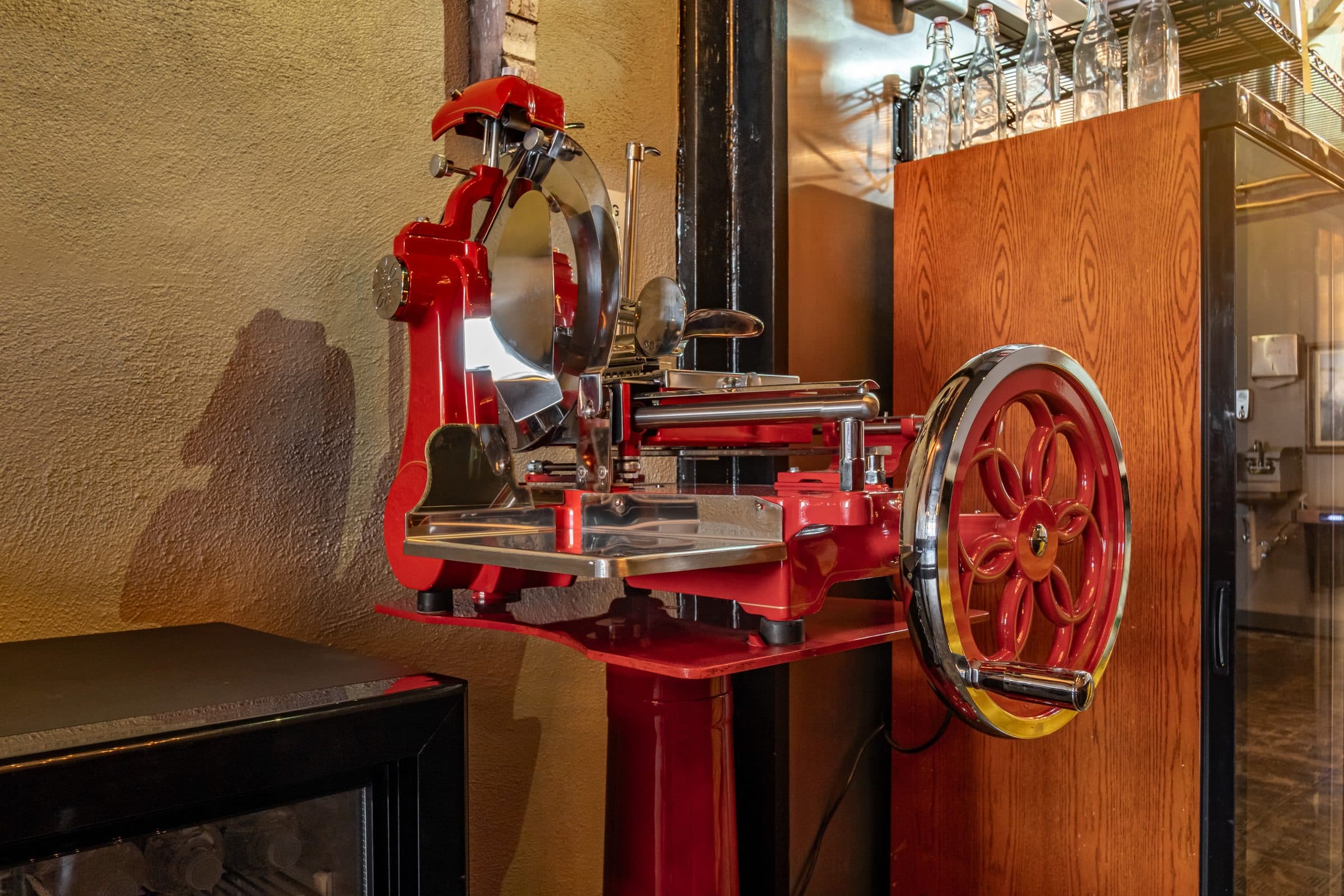 Red Berkel flywheel slicer used for charcuterie at Lot 77 Provisions