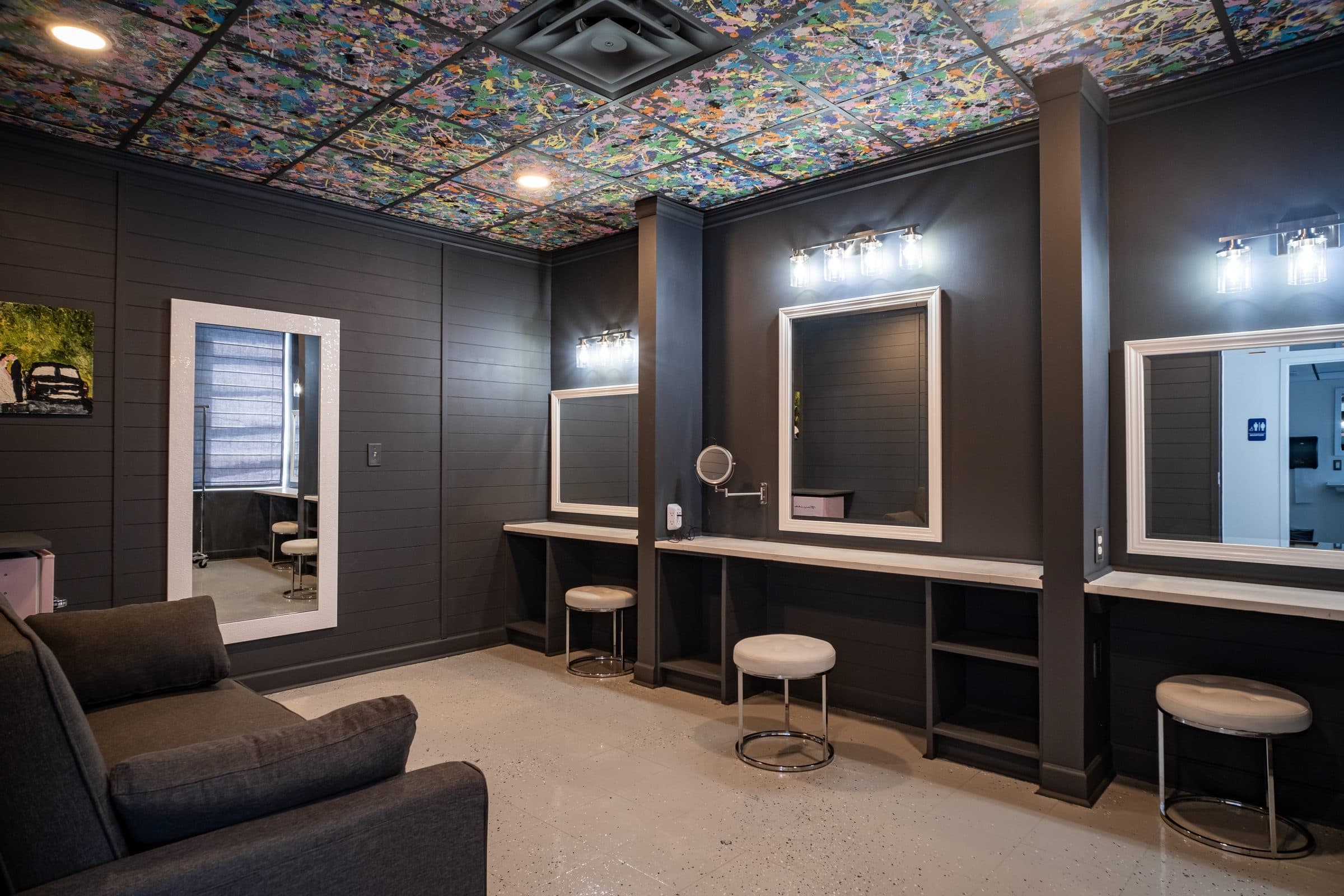 Getting-ready suite with lighted vanity mirrors and a stained-glass ceiling