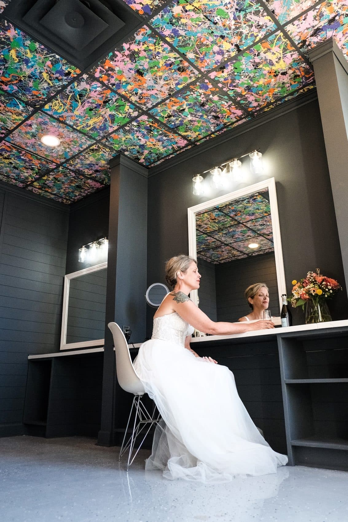 Bride seated at the vanity in the getting-ready suite